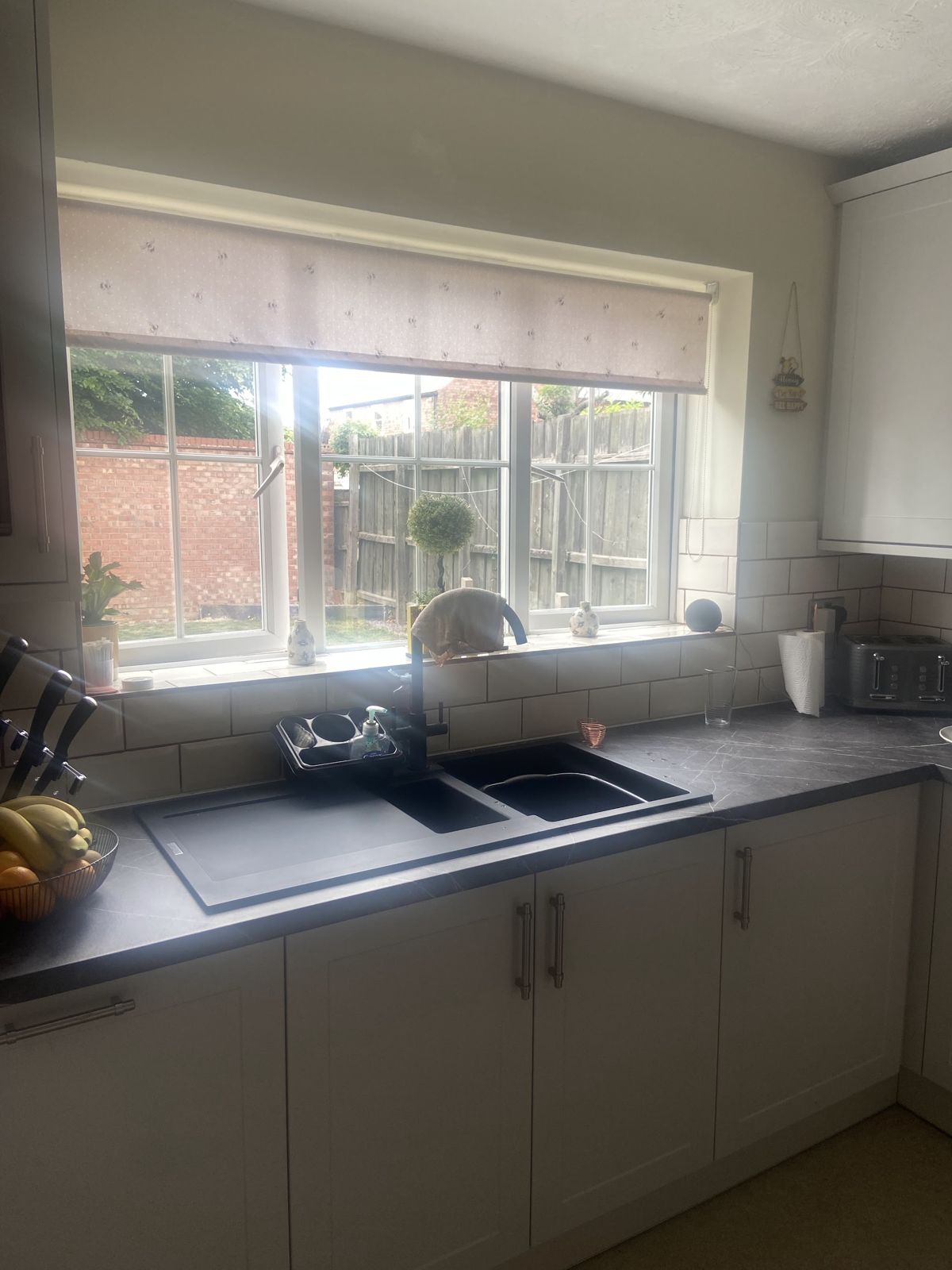 A light grey shaker kitchen fitted by Steve, with the sink under the window